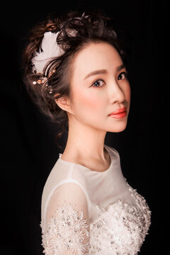 Sexy Asian wedding dress woman against a black background