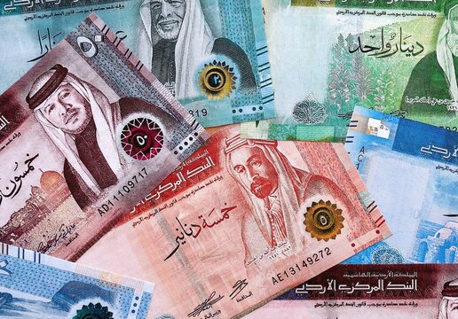 Jordanian dinar money bills pile on table. Jordan banknotes of JOD currency close up.