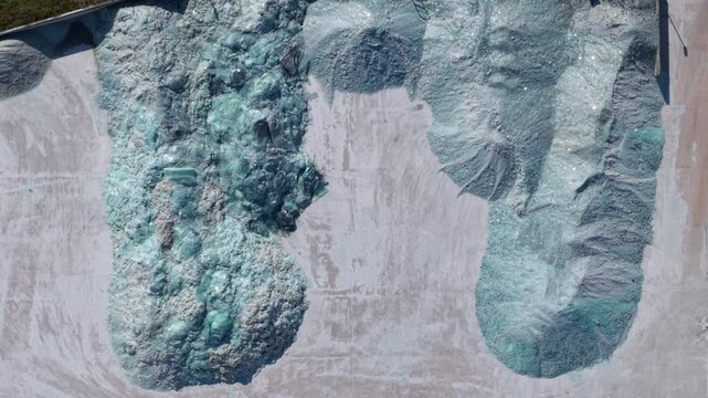 Aerial view of raw cullet piles of recycled glass material at an industrial site in Goole UK