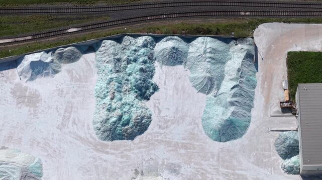 Aerial view of raw cullet piles of recycled glass material at an industrial site in Goole UK