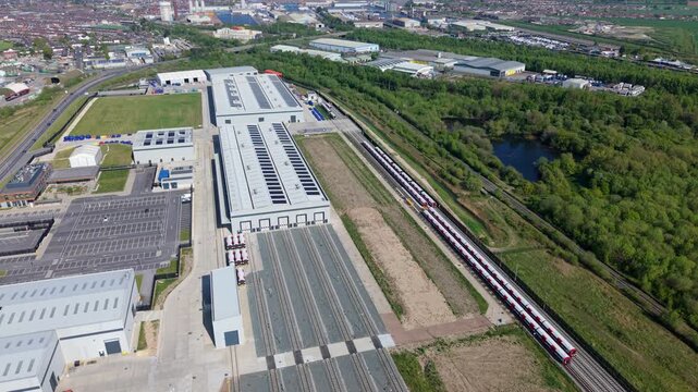 Detailed birds eye view of modern train assembly factory doors and siding tracks in England United Kingdom