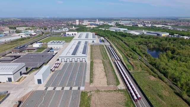 Detailed birds eye view of modern train assembly factory doors and siding tracks in England United Kingdom