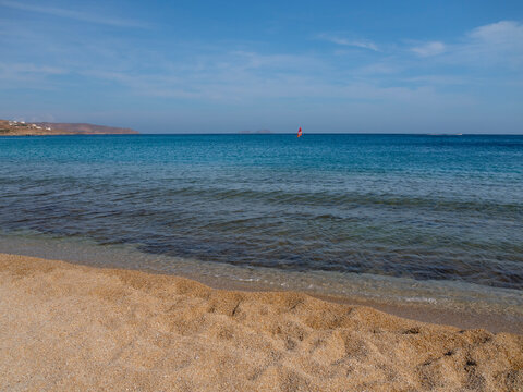 Windsurfing at Kalafati Beach in the Aegean Sea of Mykonos Island in Greece.