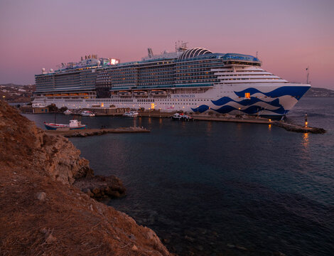 Mykonos, Greece, August 20, 2024: Cruise ship at the port on the island of Mykonos in Greece at sunset