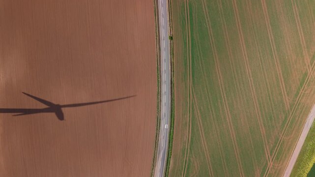Drone shot of onshore wind turbines generating renewable energy on rolling hills in South Yorkshire on a clear day