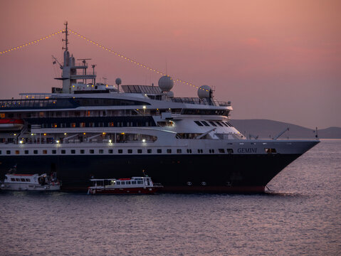 Mykonos, Greece, August 20, 2024: Cruise ship at the port on the island of Mykonos in Greece at sunset