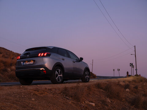 Mykonos, Greece. August 20, 2025. Modern Peugeot car at sunset on the Mykonos Island road in Greece