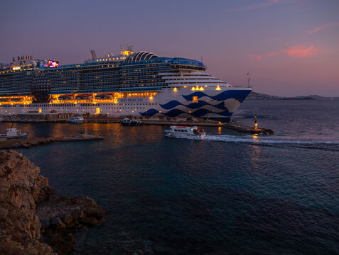 Mykonos, Greece, August 20, 2024: Cruise ship at the port on the island of Mykonos in Greece at sunset