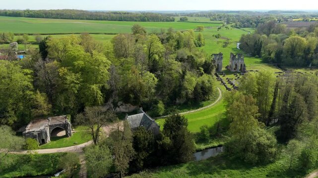 Birds eye view of an ancient gothic abbey historical landmark surrounded by green fields in England