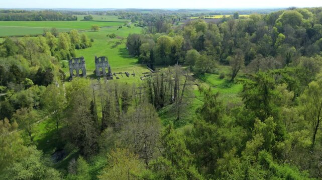 Birds eye view of an ancient gothic abbey historical landmark surrounded by green fields in England