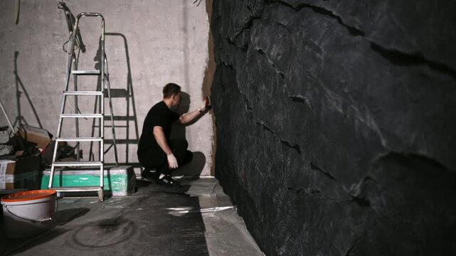 Skilled Creator Meticulously Constructs Elaborate Impostor Stone Walls Within Gritty Artistic Environment