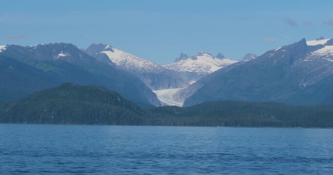 Amazing landscape of Alaska in a sunny day.Mendenhall Glacier and the surrounding mountains covered by snow.