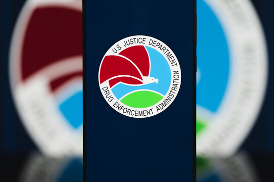 DEA logo displayed on a smartphone screen, Drug Enforcement Administration branding on mobile device for law enforcement, narcotics investigation, and federal justice communication