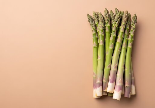 fresh green asparagus bundle on soft pink background minimalist food photography