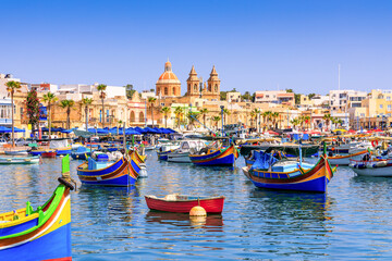 Fototapeta premium Malta, Marsaxlokk. Traditional fishing boats in the Mediterranean Village.