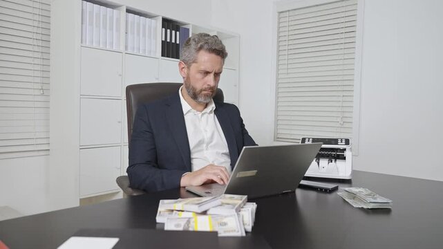 Businessman in office counting dollars. Business man with finance at desk. Businessman managing cash. Businessman work with financial operations in office. Business finance concept with businessman.