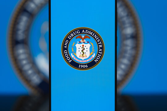 FDA logo displayed on a smartphone screen, Food and Drug Administration branding on mobile device for healthcare, medicine, and food safety regulation communication