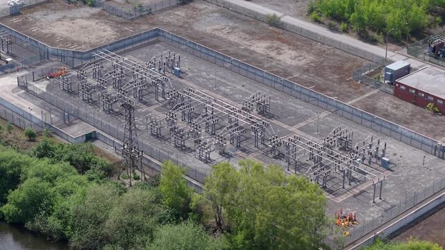 Aerial view of a small electrical substation with high-voltage lines and switchgear infrastructure in Ferrybridge, UK.