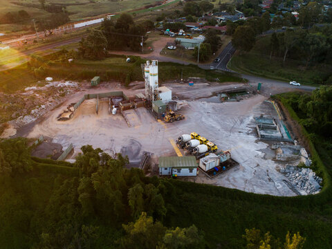 Three cement mixers parked at concrete plant facility