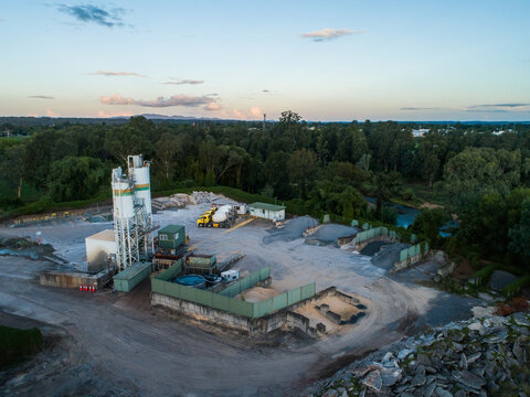cement plant factory aerial view with mixers at dusk