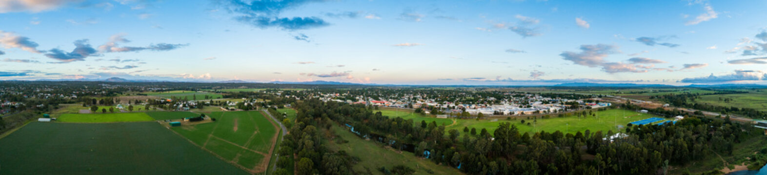 Panoramic aerial view of singleton at dusk showing Hunter River and playing fields and town