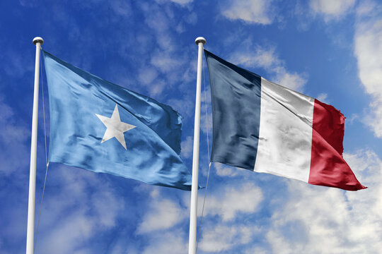 Somalia and France flags waving in a clear blue sky, symbolizing a powerful diplomacy, expanding global trade, a strategic partnership, and a shared vision of unity for a sustainable future.