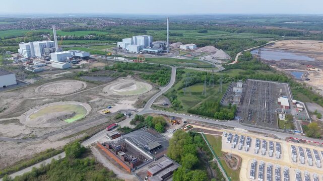 High angle aerial view tracking past twin industrial waste processing plants reducing landfill reliance