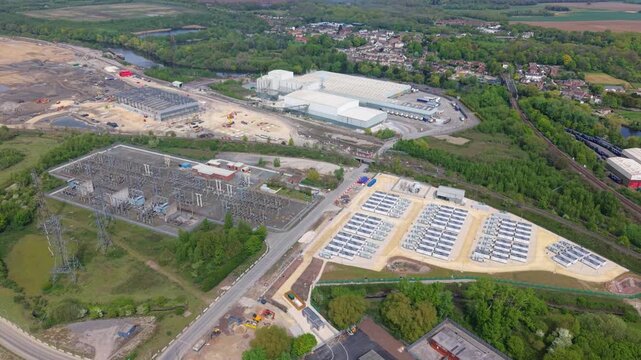 Aerial view of an electrical substation and Battery Energy Storage System BESS with an industrial facility background in Ferrybridge, UK.