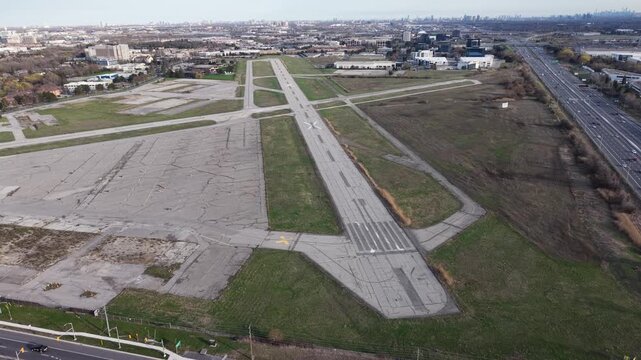 High-angle aerial shot of the vacant runways and tarmac at the decommissioned Buttonville Municipal Airport in Markham, Ontario, featuring a circular compass rose
