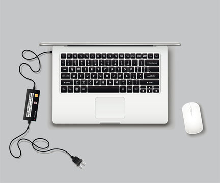Laptop top view with computer mouse and charger unplugged