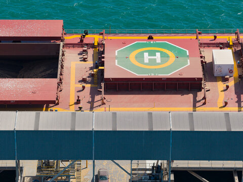 Aerial view of a heliport on a cargo ship at port