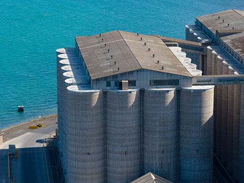 Aerial view of a bank of grain silos at a coastal port
