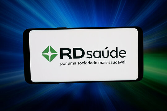 Stuttgart, Germany - 04-16-2026: In this photo illustration, the logo of company Raia Drogasil S.A. (RD Saude) is displayed on a smartphone in front of abstract background on computer screen.