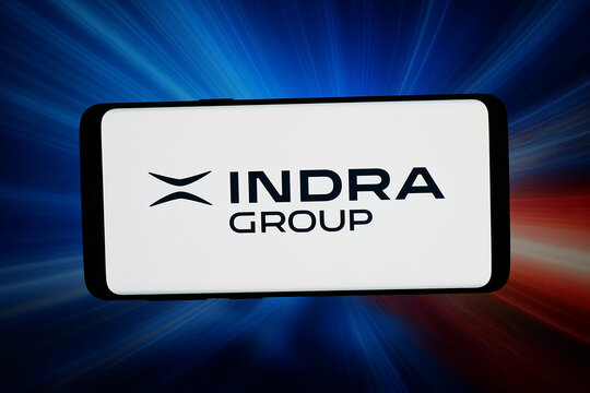Stuttgart, Germany - 04-16-2026: In this photo illustration, the logo of Spanish company Indra Sistemas S.A. is displayed on a smartphone in front of abstract background on computer screen.