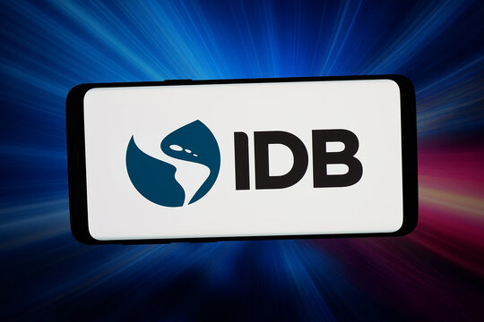 Stuttgart, Germany - 04-16-2026: In this photo illustration, the logo of Inter-American Development Bank (IDB,  IADB) is displayed on a smartphone in front of abstract background on computer screen.