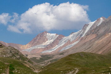Fototapeta premium A view of massive glacial formations on the slopes near Mount Satpayev in the Tien Shan Mountains.