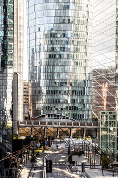 Glass skyscraper rises over an urban paris street where reflections and modern architecture meet infrastructure lines that strengthen perspective