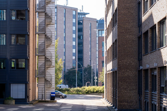 Empty residential street in oslo with urban buildings and sidewalk architecture in sunlight offers clear perspective for quiet neighborhood travel scene
