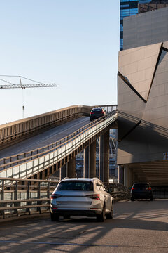 Urban stockholm motorway ramp with overpass road carries traffic cars through infrastructure while perspective lines suggest fast commuter mobility