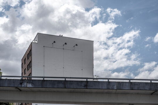 Concrete overpass facade in hamburg urban architecture under sky clouds shows minimalism and strong perspective for modern infrastructure backdrop