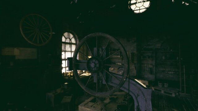 Abandoned carriage shop with rickety workbench and wheel silhouette by dirty window, dust laden beams, silent decay evoking exploration and nostalgic memory