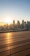 Obraz premium Golden hour sunset illuminates a modern city skyline with a wooden deck and glass railing in the foreground offering a panoramic urban view.