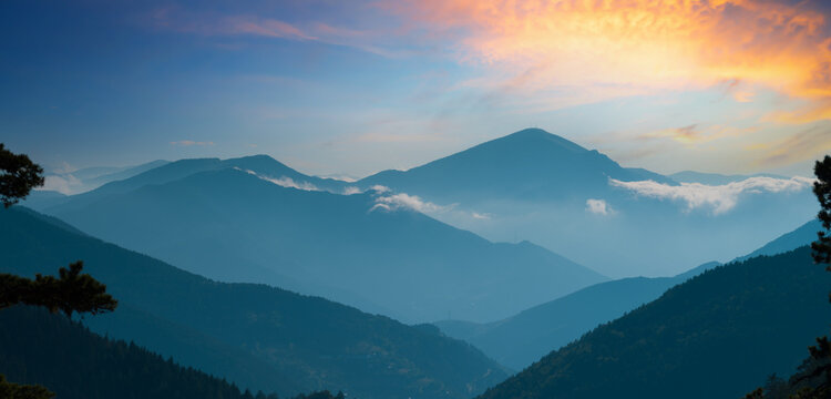 Beautiful views of the mountain ranges. Misty peaks and sunset silhouettes.