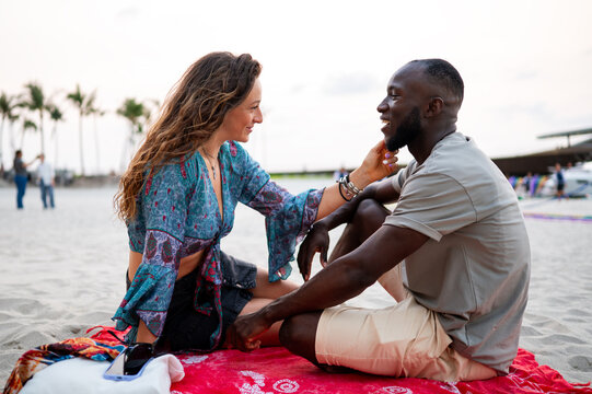 Couple sharing an intimate conversation, focusing on connection, emotional bonding on the beach