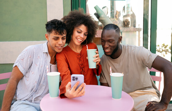 A group of multicultural university friends enjoys online shopping and fun moments together