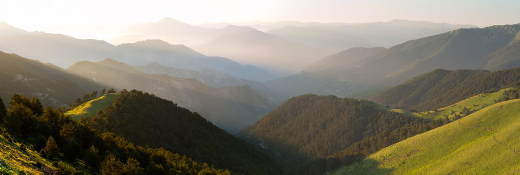 Beautiful views of the mountain panoramic ranges. Misty peaks and sunset silhouettes.