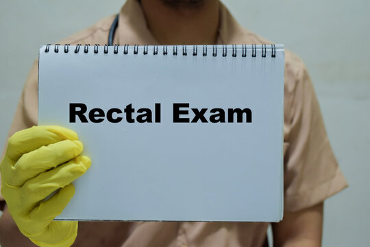 Doctor holds in hands a book with the name of the rectal exam. Medical concept