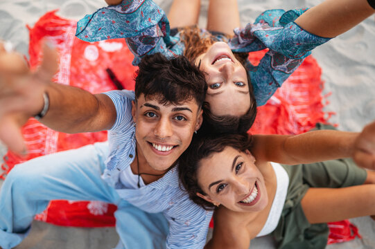 Friends traveling together, embracing adventure, laughter and unforgettable beach fun during a trip