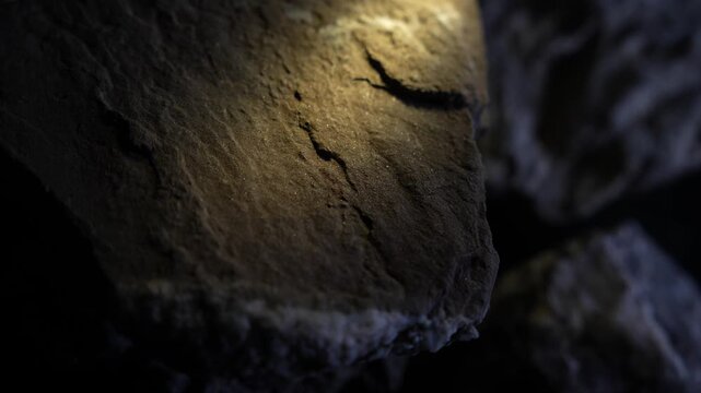 Soft warm light over smooth rock surface with subtle cinematic texture