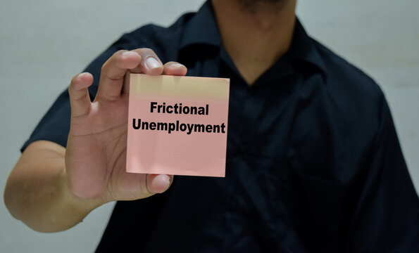 Businessman holds in hands a card with the name of the frictional unemployment.